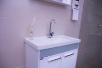 a bathroom with a white sink and a shower at Pousada Mama África in Conservatória
