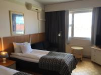 Postel nebo postele na pokoji v ubytování Finlandia Hotel Fooninki