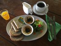 a plate of food with a sandwich and a cup of coffee at Oon Lee Bungalows in Ko Jum