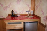 a kitchen with a red counter and a sink at Cingjing Vienna Pleasance Cottage in Ren&#39;ai