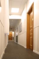 an empty hallway in a hospital with a door at Hotel Genova Liberty in Genoa