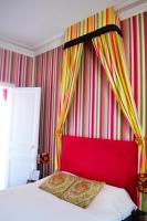 a bedroom with a bed with a red head board at Hotel Windsor Home in Paris