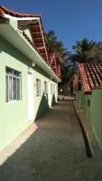 an empty alley between two green and white buildings at Pousada Mama África in Conservatória