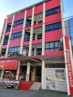 un edificio rojo con un cartel delante en Hotel Rio Branco, en Jequié