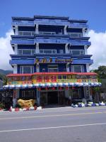 a blue building with a sign in front of it at Sansendai Sea View B&amp;B in Chenggong