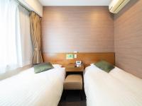 Natural Hot Spring SUPER HOTEL Kumamoto Chamber of Commerceにあるベッド