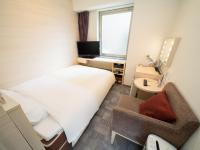 Natural Hot Spring SUPER HOTEL Kumamoto Chamber of Commerceにあるベッド
