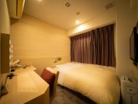 Natural Hot Spring SUPER HOTEL Kumamoto Chamber of Commerceにあるベッド