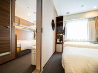 Natural Hot Spring SUPER HOTEL Kumamoto Chamber of Commerceにあるベッド