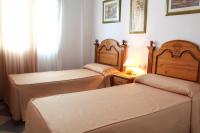 Posteľ alebo postele v izbe v ubytovaní Apartamentos Niña de Oro