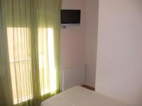 A television and/or entertainment centre at Hostal La Vila