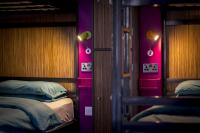 a bedroom with two bunk beds and purple walls at Kick Ass Greyfriars (18+) in Edinburgh