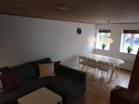 a living room with a couch and a table at Aalborg City Rooms ApS in Aalborg