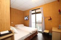 a small bedroom with a bed and a window at Zhongshan Hostel in Fenchihu