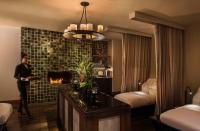 a woman standing in a hotel room with a fireplace at The Peninsula Chicago in Chicago