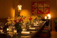 a long table with plates and glasses and flowers at The Peninsula Chicago in Chicago