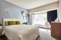 a bedroom with a large white bed and a window at Via Loft Hotel in Taipei