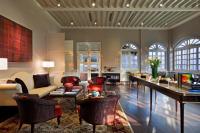 a living room with a couch and a table and chairs at Capella Singapore in Singapore