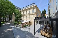 a group of people sitting outside of a hotel room at Wilson Palace by LOFT in Bratislava