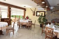 a dining room with tables and chairs and a fireplace at Hotel &quot;VIR&quot; in Velika Plana