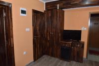 a living room with a television and a cabinet at Hotel &quot;VIR&quot; in Velika Plana