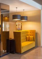 a yellow couch in a room with a mirror at Lutecia Smart Design Hotel in Lisbon
