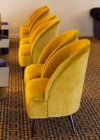 a row of yellow chairs in a waiting room at Lutecia Smart Design Hotel in Lisbon
