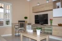 A television and/or entertainment centre at VILLA OLIVEIRA by Buenavilla