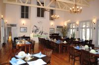 a dining room with tables and chairs in a restaurant at Delta Nature Resort in Tulcea