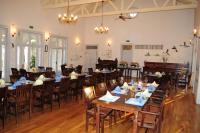 a dining room with tables and chairs and birds on the ceiling at Delta Nature Resort in Tulcea
