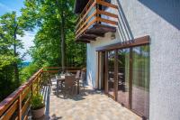 a balcony of a house with a table and chairs at Holiday Home Vanda in Bakar