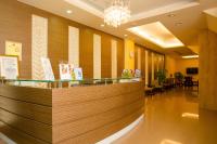 a lobby with a reception counter and a restaurant at Garden Hotel in Taichung