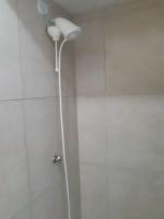 a shower in a bathroom with a shower head at Hotel Nils in Itapoa