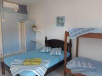 a bedroom with a bed and a bunk bed at Hotel Nils in Itapoa