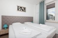Łóżko lub łóżka w pokoju w obiekcie Apartamenty Aquamarina by Noclegi Renters