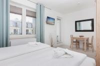 Łóżko lub łóżka w pokoju w obiekcie Apartamenty Aquamarina by Noclegi Renters
