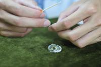 a person is holding a needle and a piece of jewelry at Tai-Yi Red Maple Resort in Puli