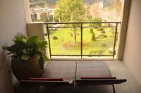 a room with a view of a garden from a window at Tai-Yi Red Maple Resort in Puli