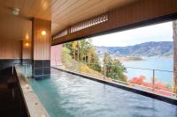 a swimming pool with a view of the water at Rakuyu in Fujikawaguchiko