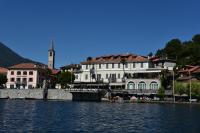a group of buildings next to a body of water at Hotel Due Palme in Mergozzo
