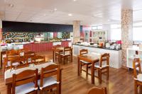 a restaurant with wooden tables and chairs and a counter at Paraiso del Sol y Paradero in Playa de las Americas