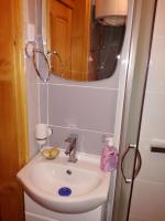 a bathroom with a sink and a mirror at Pešić Apartmani in Kušići