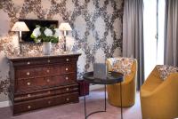 a room with a dresser and a table with a laptop on it at Hôtel du Danube Saint Germain in Paris