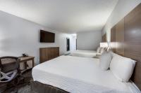 a bedroom with a bed and a desk and a chair at Red Lion Inn &amp; Suites Grants Pass in Grants Pass