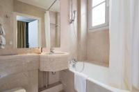 a bathroom with a sink and a shower and a tub at Hôtel du Danube Saint Germain in Paris