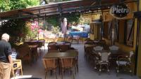 a group of tables and chairs at a restaurant at Le FLORIDA in Zicavo