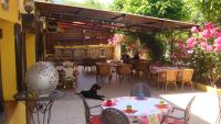 a black dog sitting on a patio at a restaurant at Le FLORIDA in Zicavo