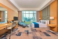 a hotel room with a bed and a desk and a computer at Canal Central Hotel Business Bay in Dubai