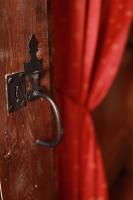 a close up of a door with a red curtain at Domaine de la Saule in Jalogny