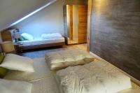 a bedroom with two beds and a mirror at Camping Bissen in Esch-sur-Sûre